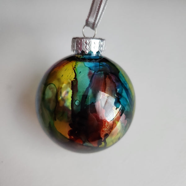 Colorful one-of-a-kind plastic ornament with alcohol ink design.