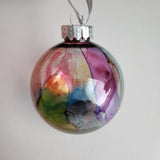 Colorful one-of-a-kind plastic ornament with alcohol ink design.