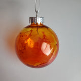 Colorful one-of-a-kind plastic ornament with alcohol ink design.