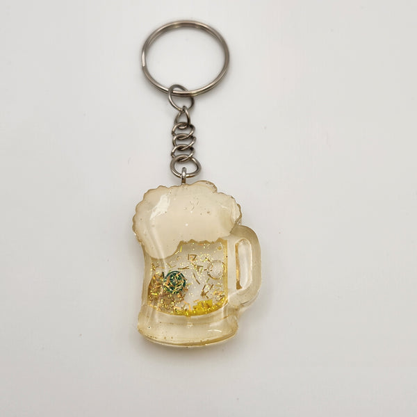 Beer shaker keychain filled with oil and floating charms
