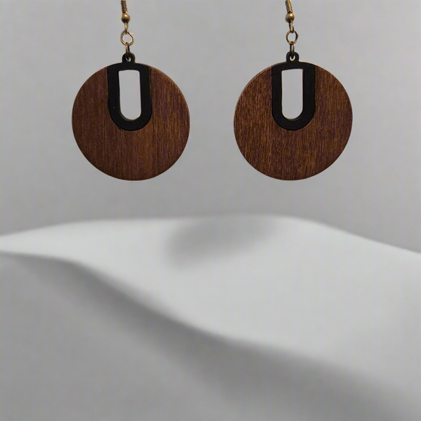 Round stained wood earrings with black-painted accents and keyhole cutout on brass hooks