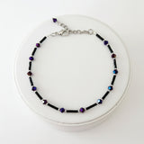 Handmade black and purple iridescent glass bead ankle bracelet by Blue Bourbon Designs.