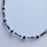 Handmade black and red iridescent glass bead ankle bracelet by Blue Bourbon Designs