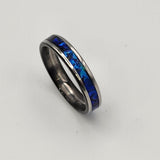 Hand-turned dichroic resin ring on a 2mm stainless steel band shifting blue and green in the light