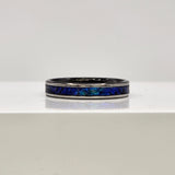 Hand-turned dichroic resin ring on a 2mm stainless steel band shifting blue and green in the light