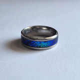 Hand-turned dichroic resin ring on a 4mm stainless steel band shifting blue and green in the light