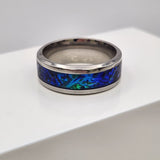 Hand-turned dichroic resin ring on a 4mm stainless steel band shifting blue and green in the light