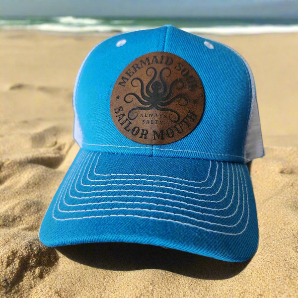 Turquoise trucker hat with dark brown faux leather patch reading Mermaid Soul, Sailor Mouth by Blue Bourbon Designs