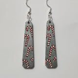 A pair of hand-painted candy cane earrings with 925 sterling silver hooks.