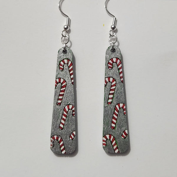 A pair of hand-painted candy cane earrings with 925 sterling silver hooks.