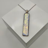 Caribbean dichroic pendant with iridescent Dichrolam resin on stainless steel chain.