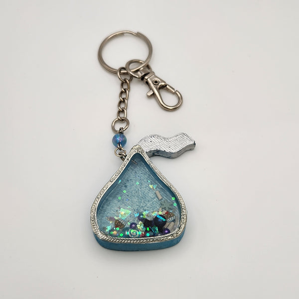 Chocolate drop shaker keychain filled with oil and floating charms