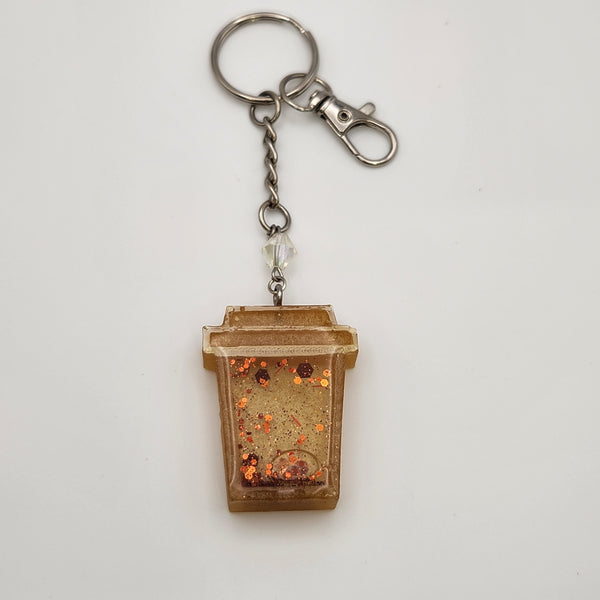 Coffee shaker keychain filled with oil and floating charms