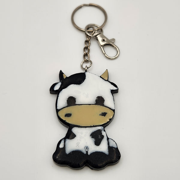 Hand-painted resin cow keychain sealed with clear resin