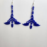 A pair of blue dragon-shaped earrings with silver hooks.