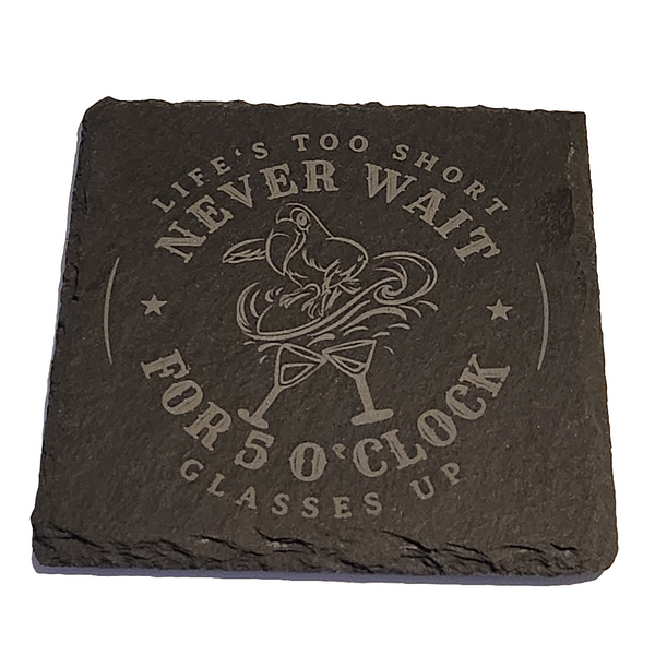 A black slate coaster with an engraved image that includes the phrase 'Life's too short
