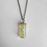 Faux opal resin necklace with iridescent color-shifting material on stainless steel chain