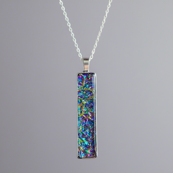 Fire burl dichroic pendant with iridescent Dichrolam resin on stainless steel chain.
