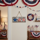 Wooden plaque with three star-shaped decorations in blue, red, and white 