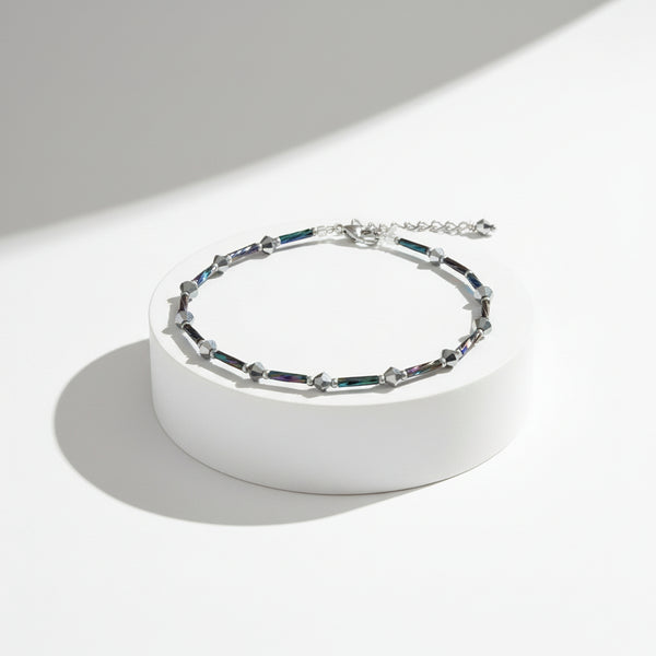 Adjustable ankle bracelet with a chain and multicolored beads.