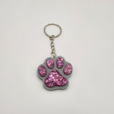 Hand-poured resin pawprint keychain supporting animal rescue