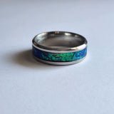 Hand-turned green dichroic resin ring shifting blue and green in the light