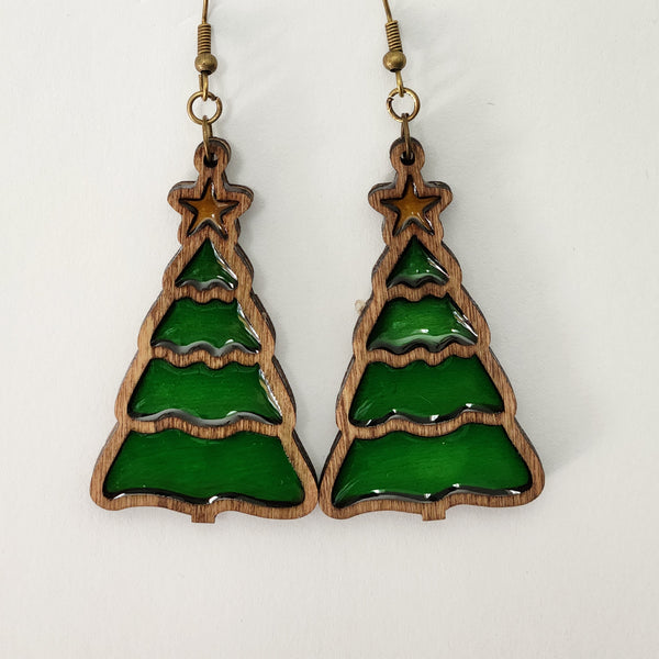 A pair of earrings featuring a Christmas tree design with a green resin and brown wood