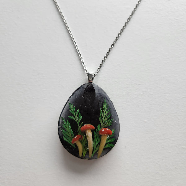 Handmade mushroom necklace with clay mushrooms and real green florals in resin