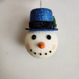 Handcrafted snowman ornament with snowy texture and glitter hat by Blue Bourbon Designs