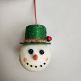 Handcrafted snowman ornament with snowy texture and glitter hat by Blue Bourbon Designs