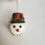 Handcrafted snowman ornament with snowy texture and glitter hat by Blue Bourbon Designs