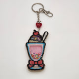 Ice-cream shake shaker keychain filled with oil and floating charms.