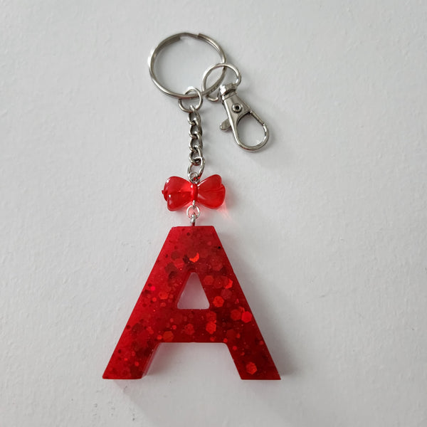 Hand-poured resin initial keychain with charms