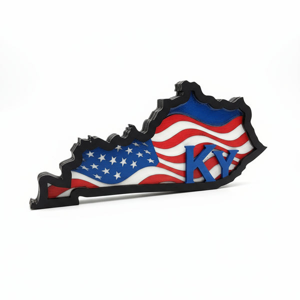 Decorative item shaped like the state of Kentucky with American flag design on a white surface.