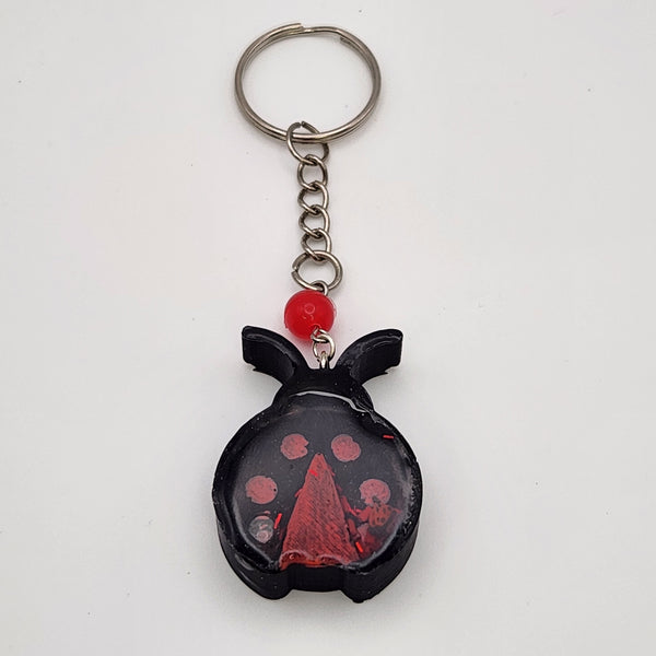 Ladybug shaker keychain filled with oil and floating charms.