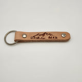 Laser-engraved leather key fob keychain with detailed design.