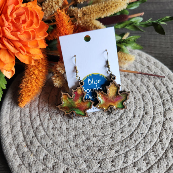 Maple leaf earrings made from laser cut wood and hand-poured resin with brass hooks