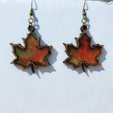 Maple leaf earrings made from laser cut wood and hand-poured resin with brass hooks