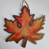 Handmade wooden maple leaf filled with resin in fall colors by Blue Bourbon Designs