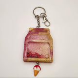 Milk carton shaker keychain filled with oil and floating charms