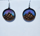 One-of-a-kind mountain earrings made from laser cut wood and resin with stainless steel hooks