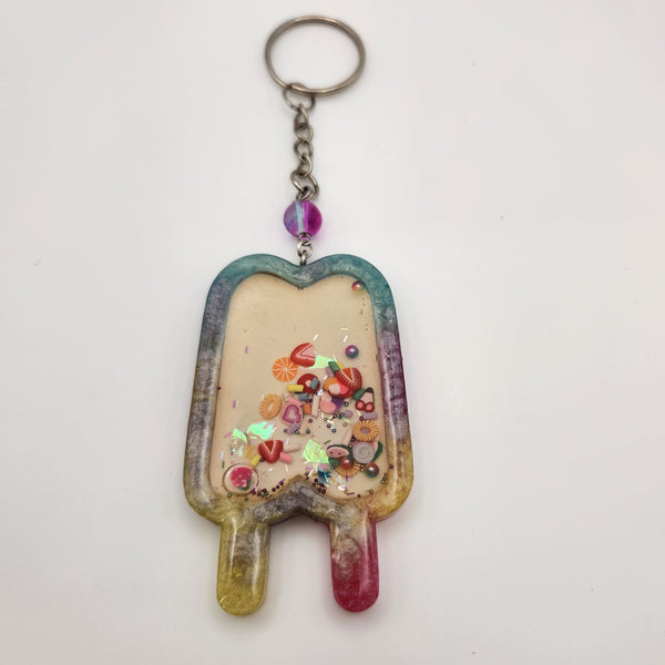 Double popsicle shaker keychain filled with oil and floating charms.