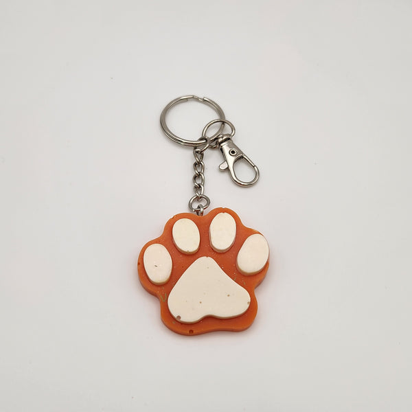 Hand-poured resin pawprint keychain supporting animal rescue