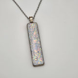 Pearl dragon burl dichroic pendant with iridescent Dichrolam resin on stainless steel chain.