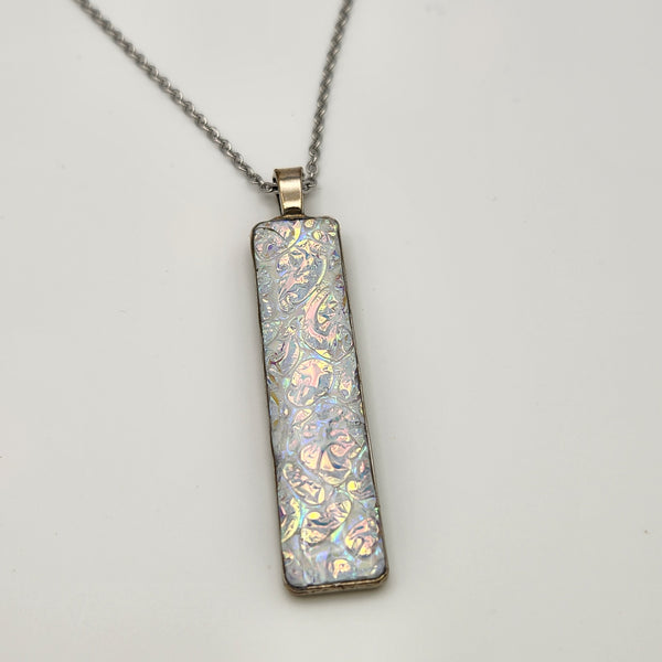 Pearl dragon burl dichroic pendant with iridescent Dichrolam resin on stainless steel chain.