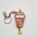 Penguin drink shaker keychain filled with oil and floating charms.