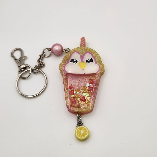 Penguin drink shaker keychain filled with oil and floating charms.