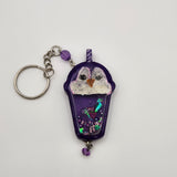 Penguin drink shaker keychain filled with oil and floating charms.