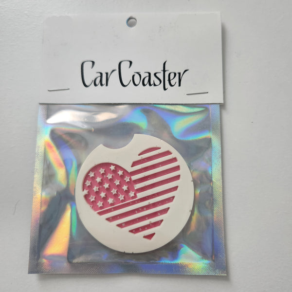 A round, pink, white, and red flag-shaped car coaster