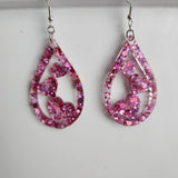 Teardrop resin earrings with heart accents in multiple colors by Blue Bourbon Designs